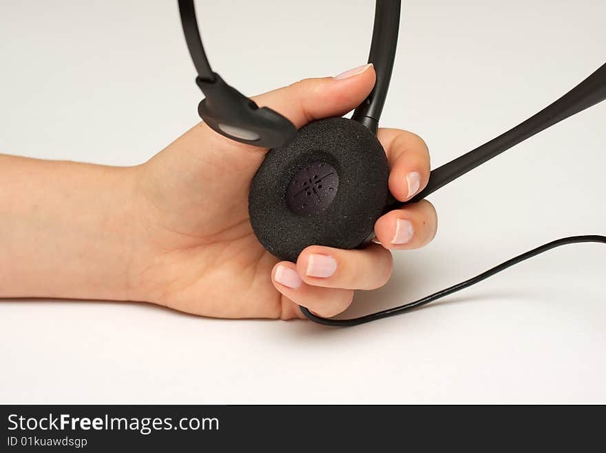 Female hand holding a telephone operator headset possibly providing support. Female hand holding a telephone operator headset possibly providing support