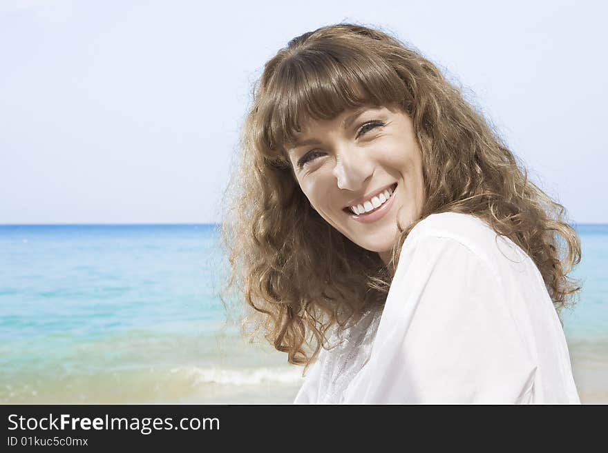 Portrait of nice young woman having good time on the beach. Portrait of nice young woman having good time on the beach