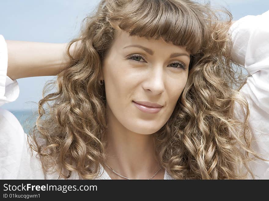 Portrait of nice young woman having good time on the beach. Portrait of nice young woman having good time on the beach