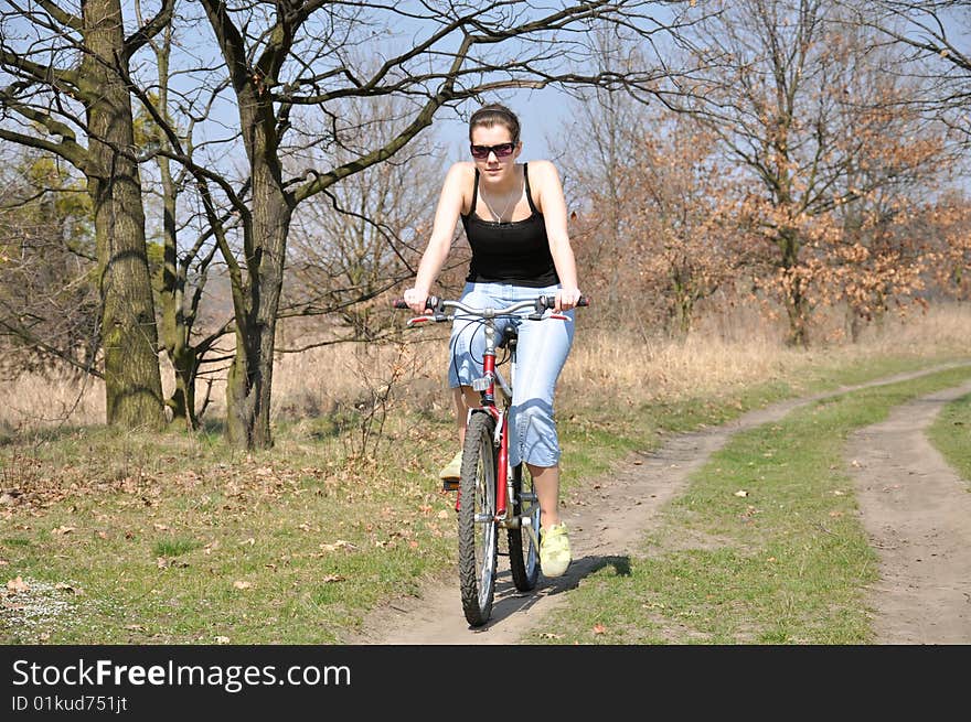 Girl riding a bike in spring scenery. Girl riding a bike in spring scenery