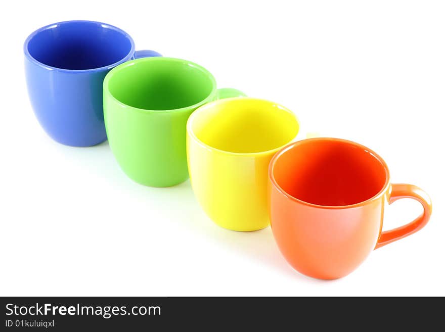 Four colored cups, isolated over white board. Four colored cups, isolated over white board