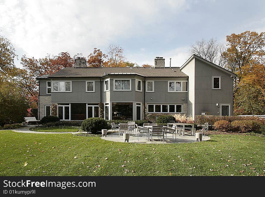 Rear view of luxury home with patio furniture