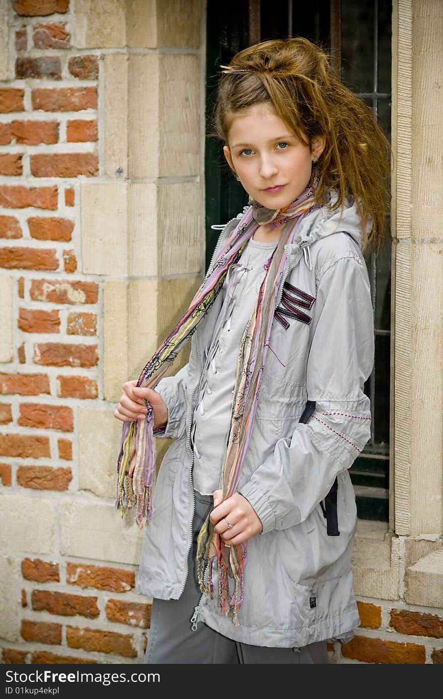 Trendy fashion teenager girl showing off new clothes against street background