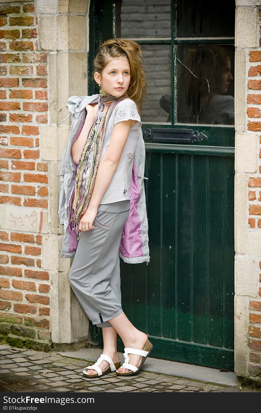 Trendy fashion teenager girl showing off new clothes against street background