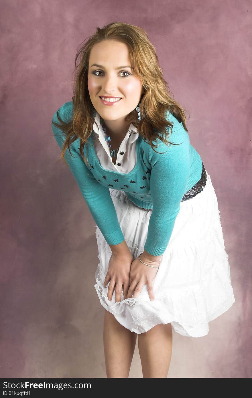 Beautiful young female wearing a white skirt and blue top