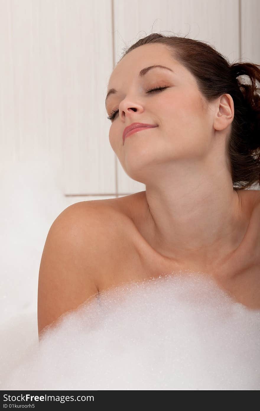 Body care - Young woman in the bathtub with foam. Body care - Young woman in the bathtub with foam