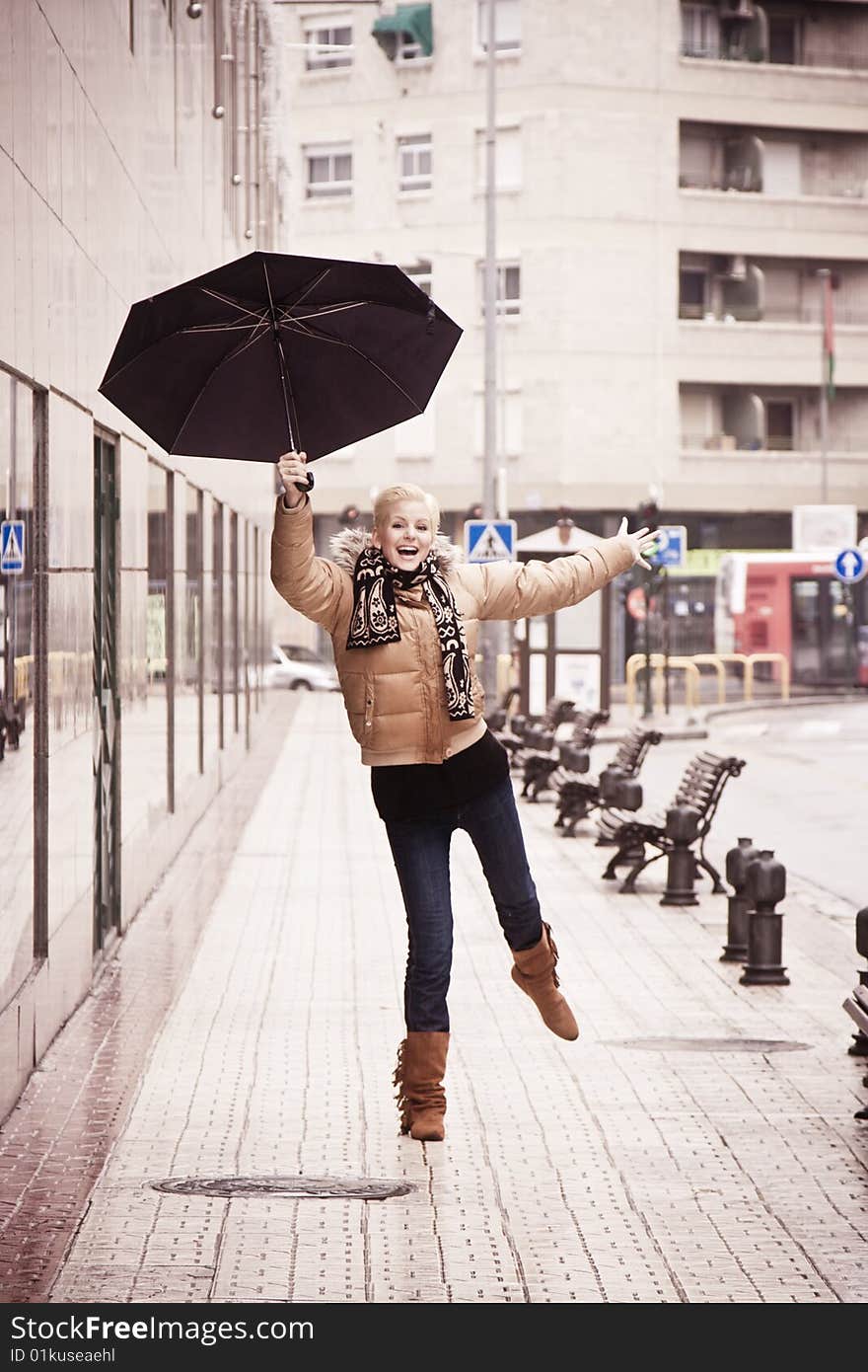 Happy young blond woman in a rainy day. Happy young blond woman in a rainy day.