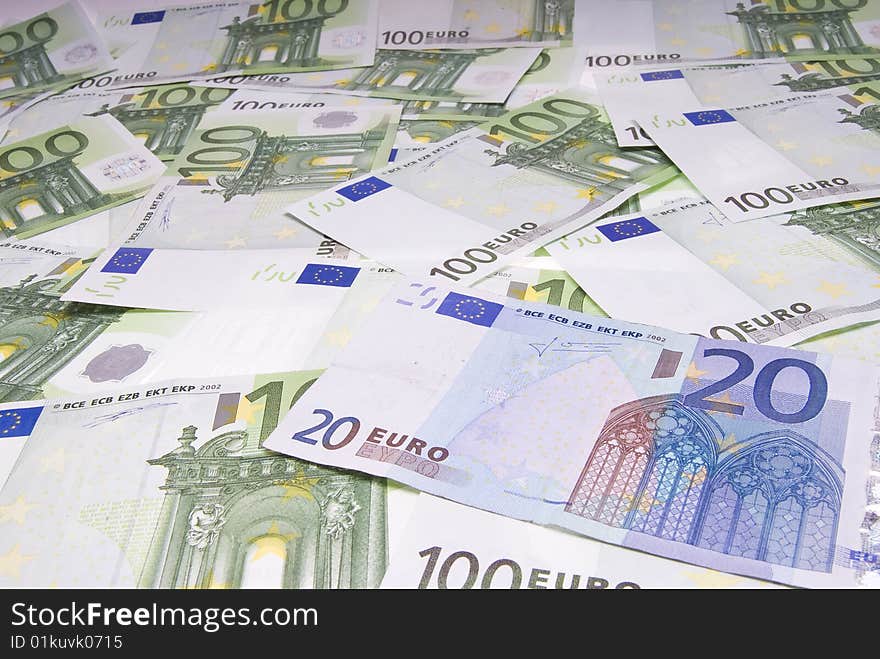 Twenty euro note placed over many hundred euro notes. Twenty euro note placed over many hundred euro notes