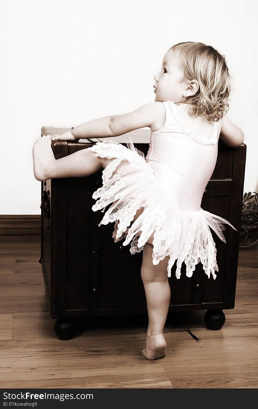 Little girl with short hair wearing a pink ballet outfit