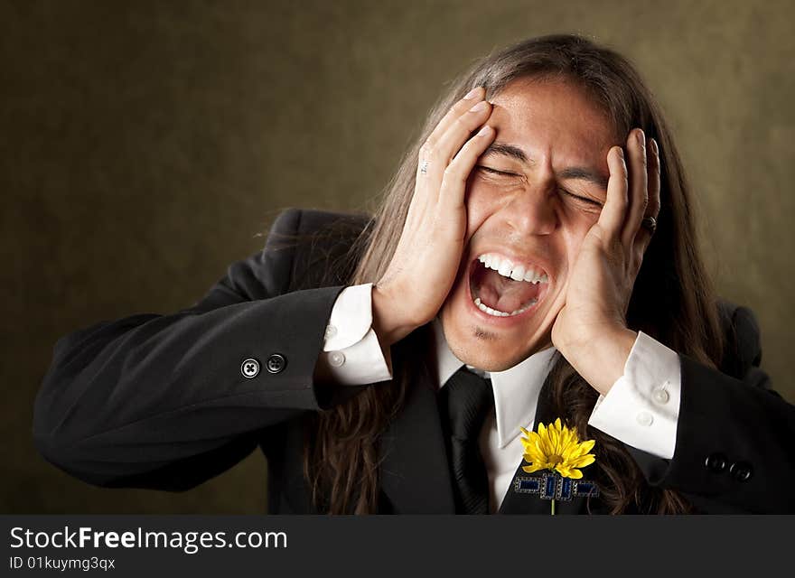 Handsome man screaming in formal jacket with boutonniere. Handsome man screaming in formal jacket with boutonniere