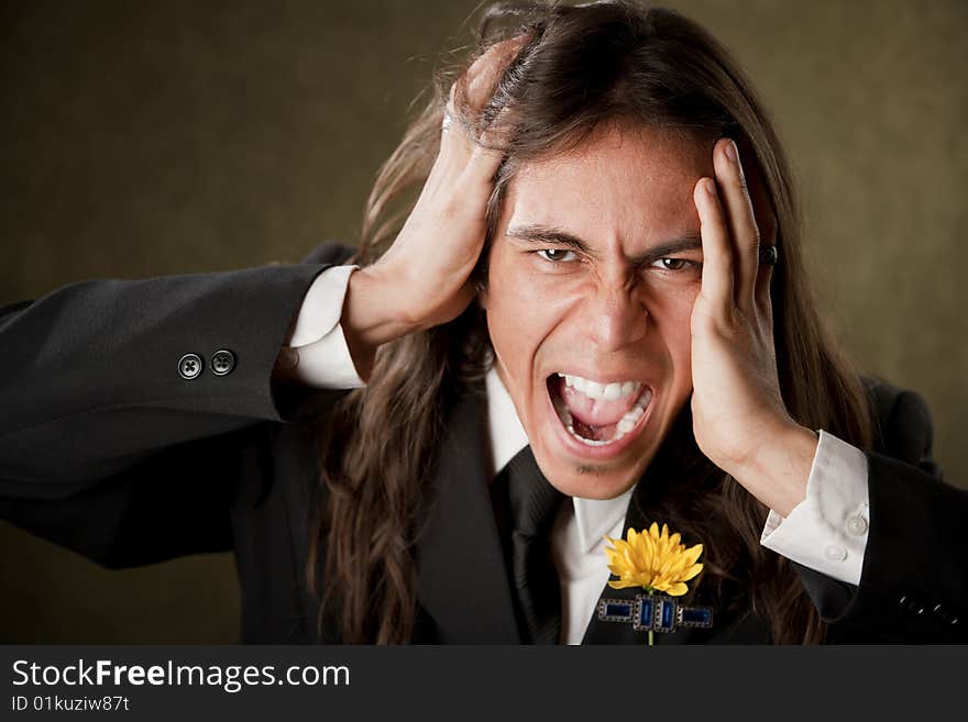 Handsome man screaming in formal jacket with boutonniere. Handsome man screaming in formal jacket with boutonniere