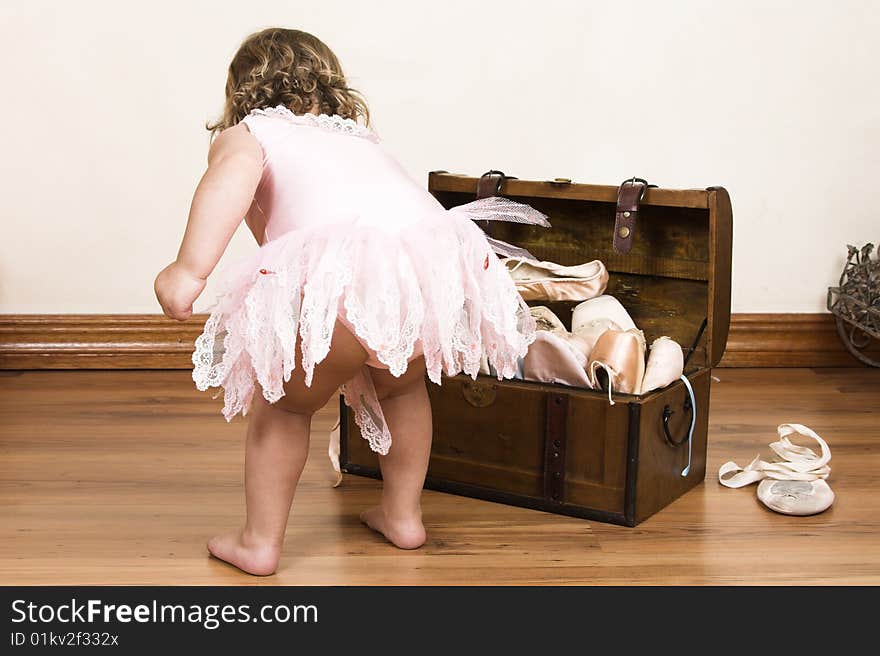 Little girl with short hair wearing a pink ballet outfit