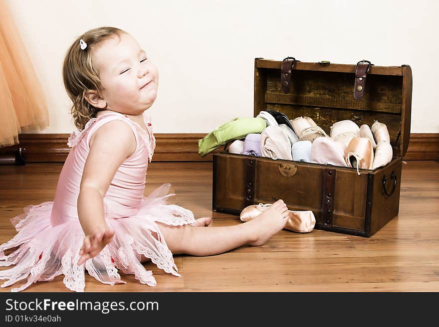 Little girl with short hair wearing a pink ballet outfit