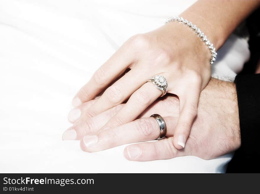 Groom holding his new bride's hand gently. Groom holding his new bride's hand gently