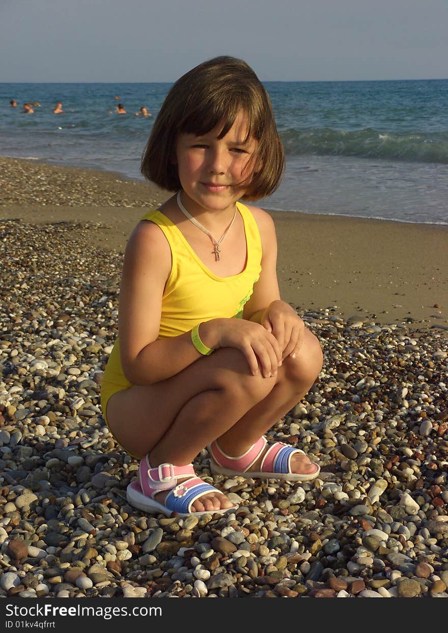 A Girl Plays On The Beach At Water