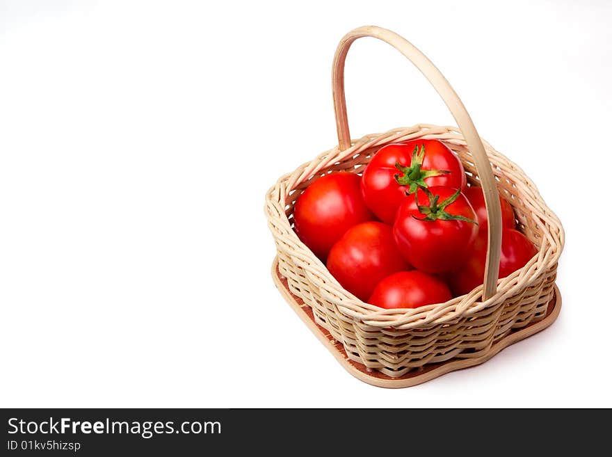 Fresh tomato  in a basket isolated on white background. Fresh tomato  in a basket isolated on white background