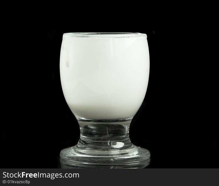 Glass with milk on a black background. Glass with milk on a black background