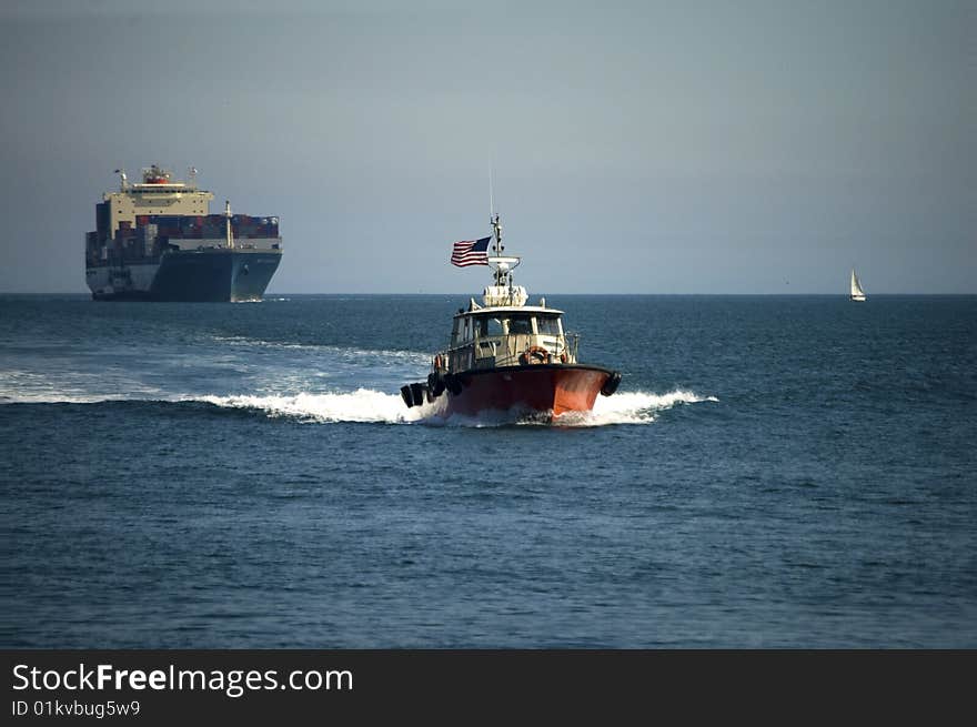 The harbor pilot returns to port after meeting a container ship. The harbor pilot returns to port after meeting a container ship.