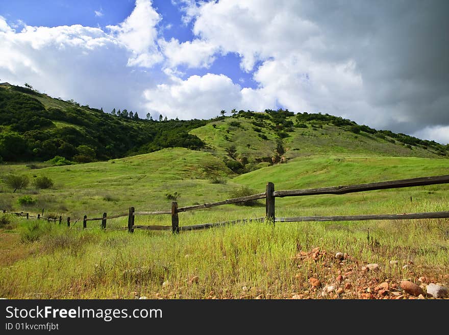 Mountain meadow with clouds in the background