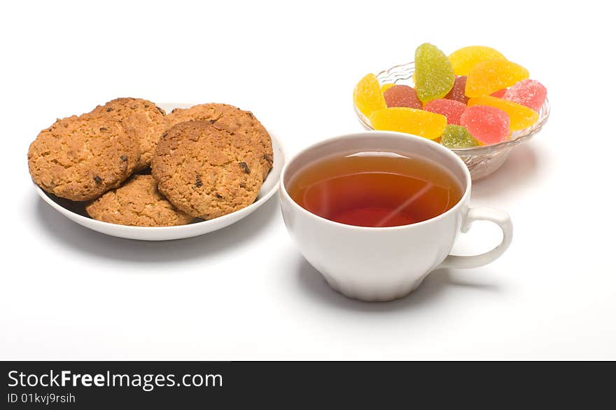 Tea colour fruit candy and cookies close up. Tea colour fruit candy and cookies close up