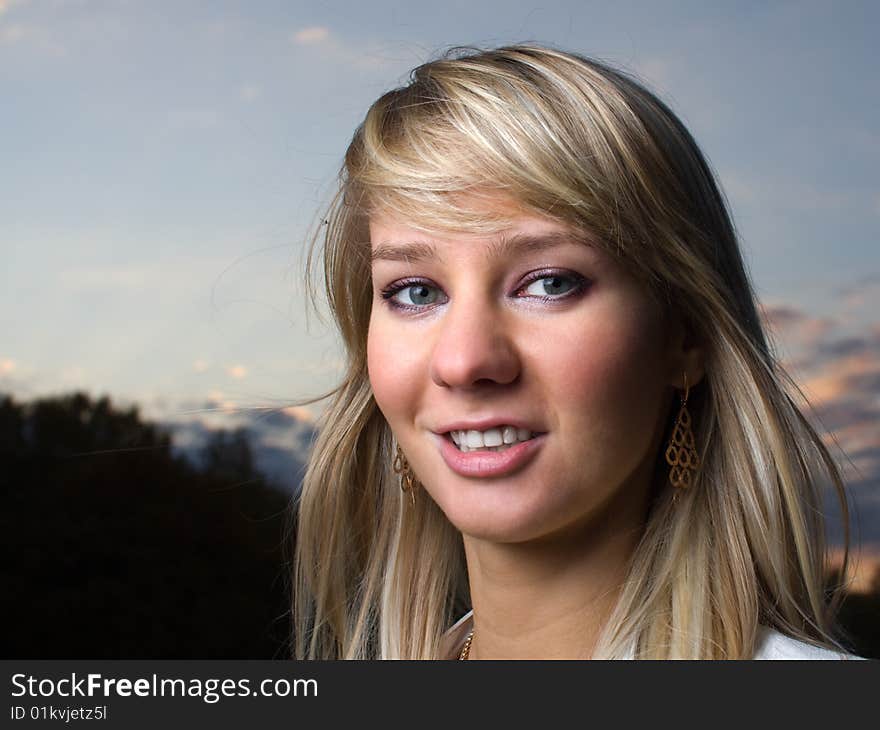 Pretty girl face portrait with soft blue sky on background