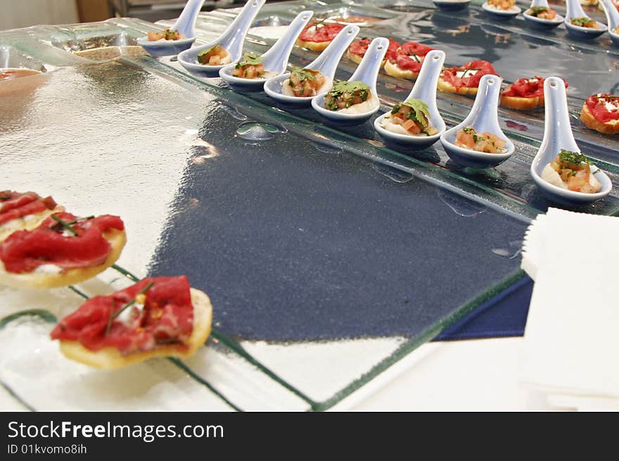 Gourmet canapes on square glass serving tray