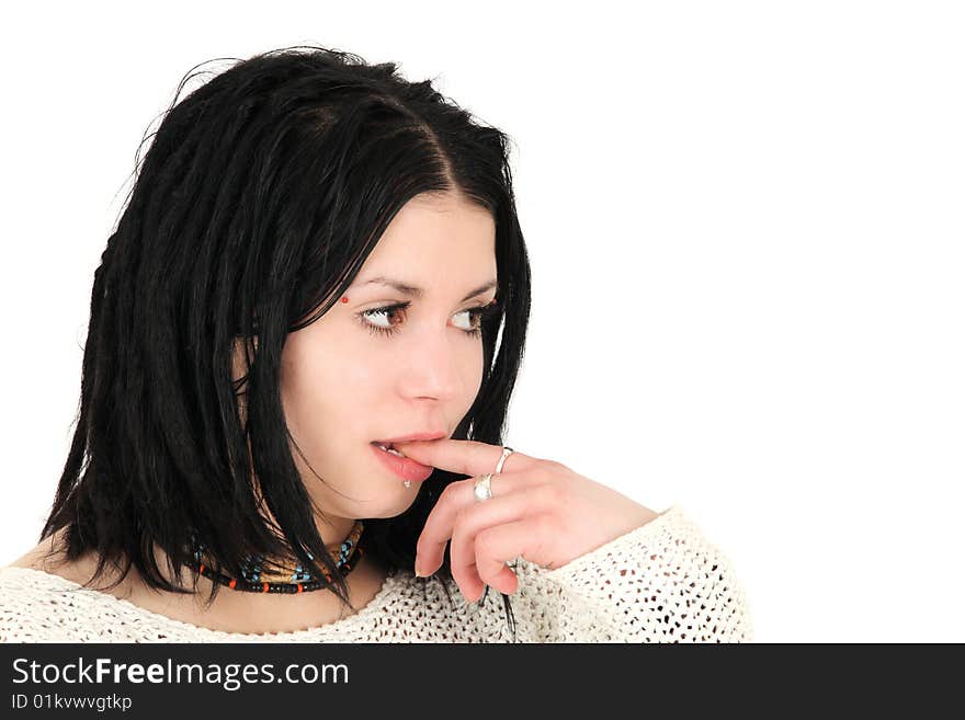 Portrait of young teenage girl with finger in mouth, studio shot