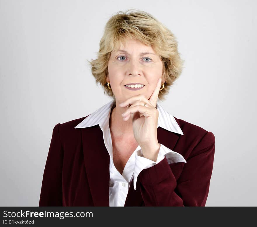 Senior businesswoman shot against a gray background. Senior businesswoman shot against a gray background