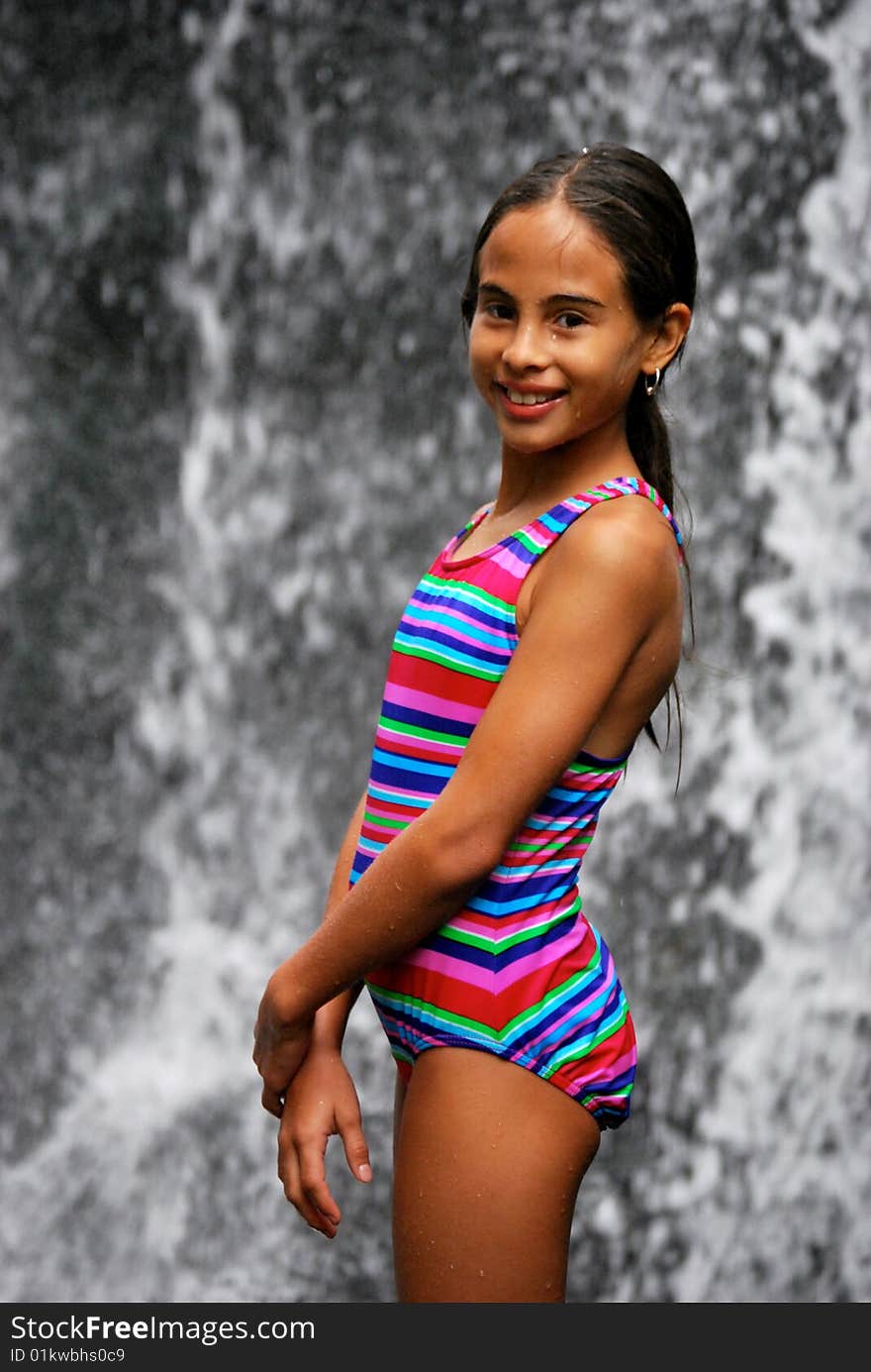 Beautiful Hispanic girl in front of a waterfall. Beautiful Hispanic girl in front of a waterfall.