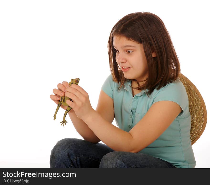 A skiddish preteen girl studying a spotted green frog as she holds him in both hands. Isolated on white. A skiddish preteen girl studying a spotted green frog as she holds him in both hands. Isolated on white.