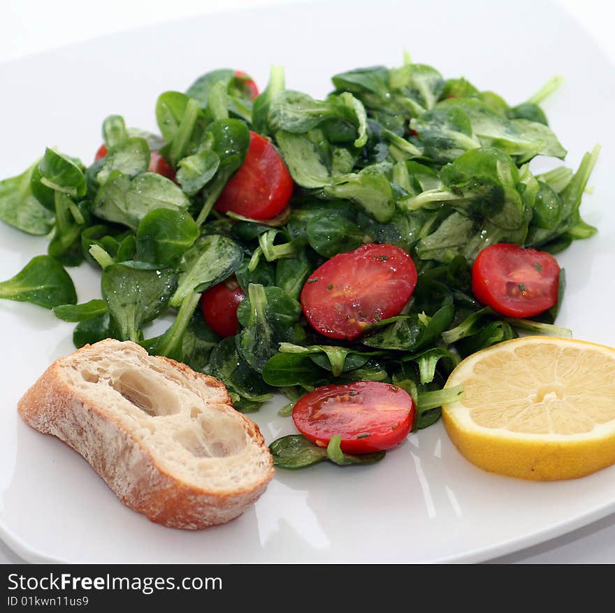 A fresh salad with tomatoes and some bread