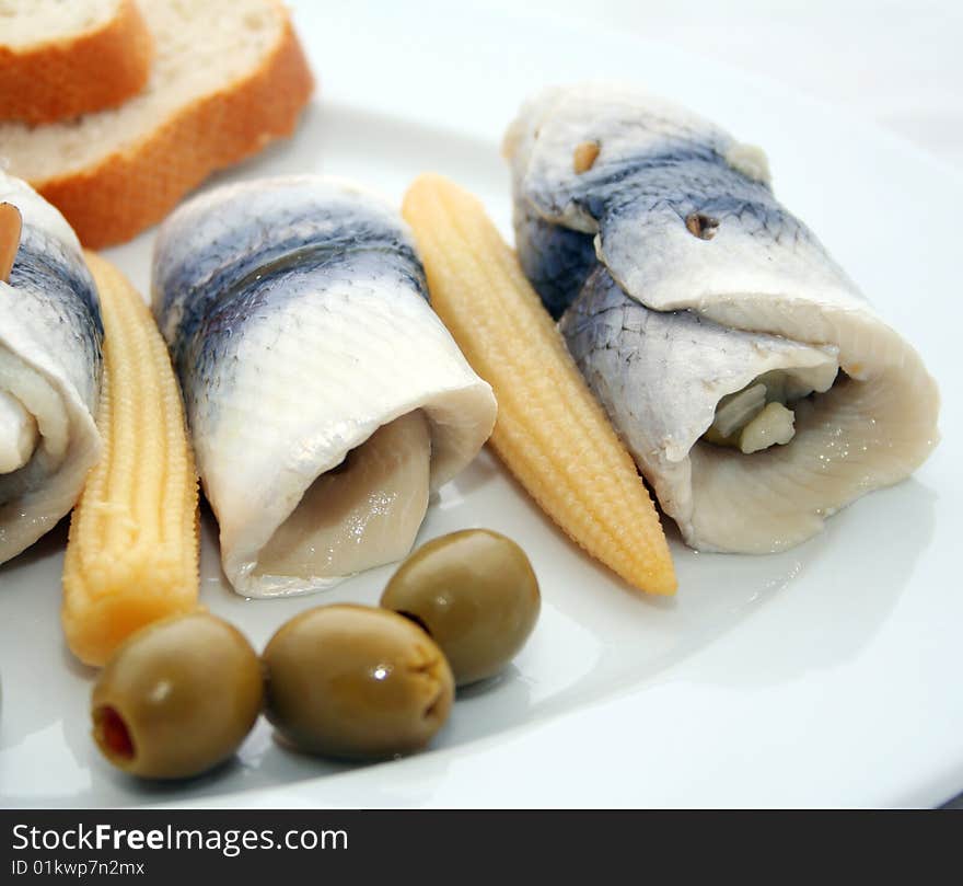 Some fresh fish with olives and corn