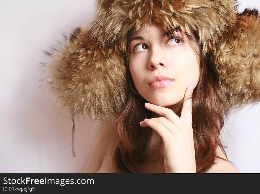 Portrait of the beautiful girl in a fur cap close up. Portrait of the beautiful girl in a fur cap close up.