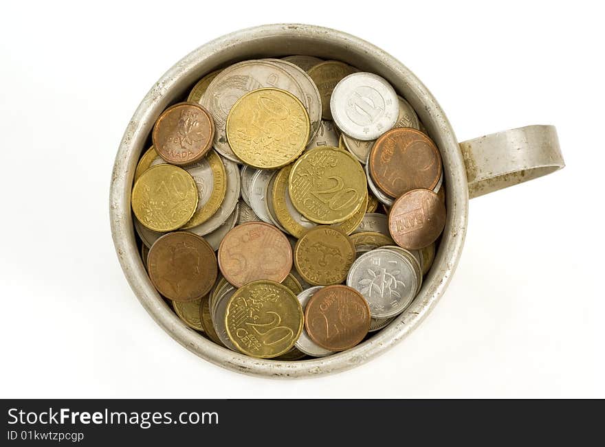 Old aluminum mug and coins  on white background. Old aluminum mug and coins  on white background.