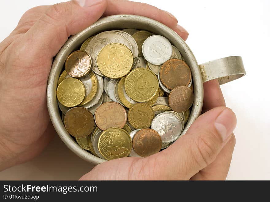 Old aluminum mug and coins.