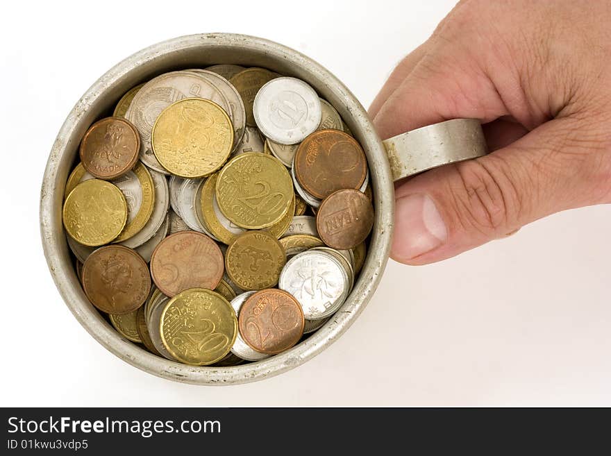 Old aluminum mug and coins.