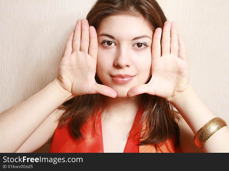 Beautiful brunette young woman frame her face with palms. Beautiful brunette young woman frame her face with palms.