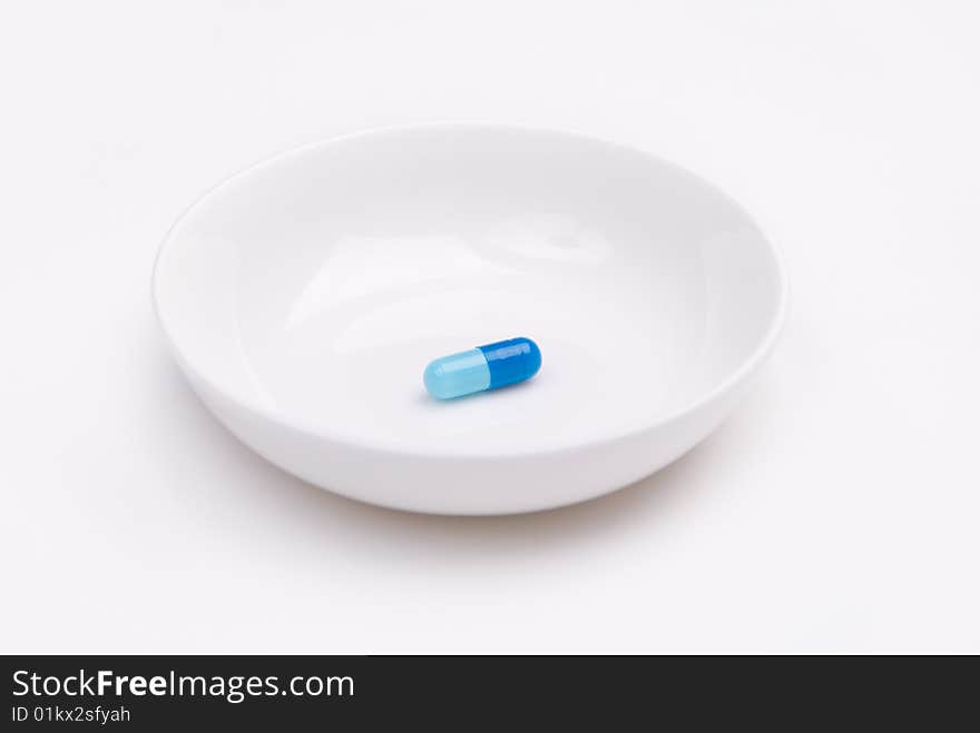 Blue pill on a plate