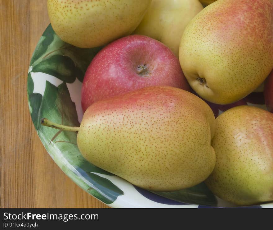 Bowl of red and yellow pears and apples, close-up. Bowl of red and yellow pears and apples, close-up