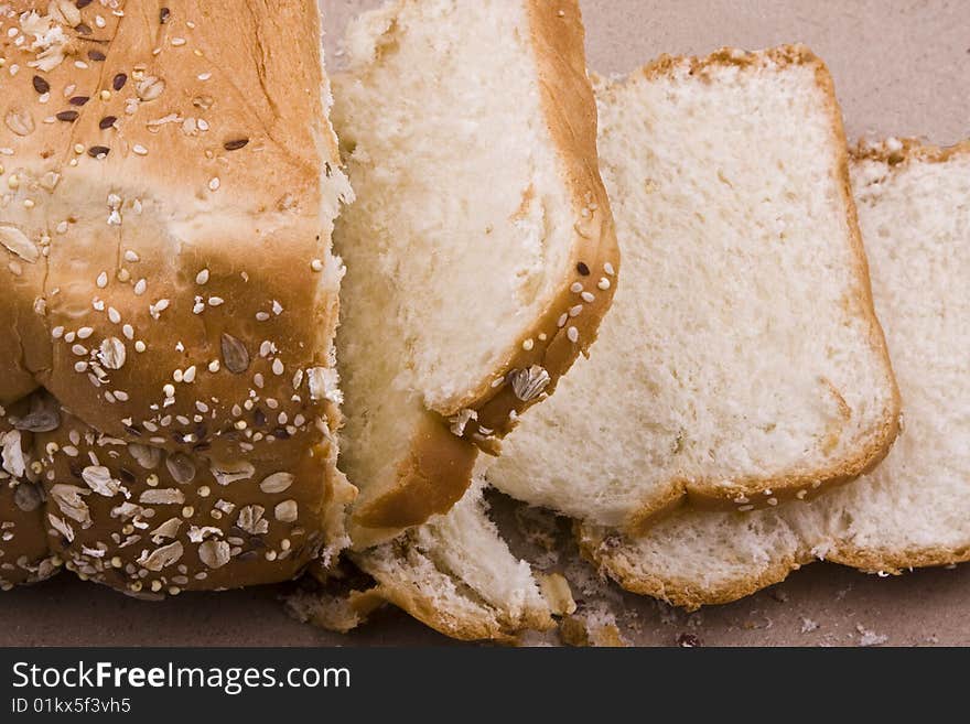 White background, bread in peieces, covered with til seed, cornmeal. White background, bread in peieces, covered with til seed, cornmeal