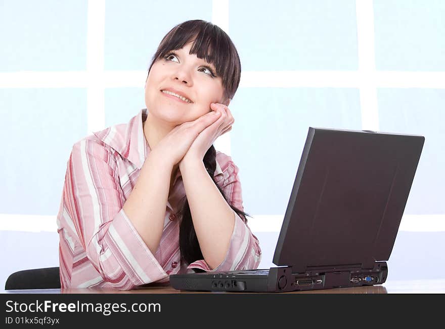 Happy brunette woman with laptop at home