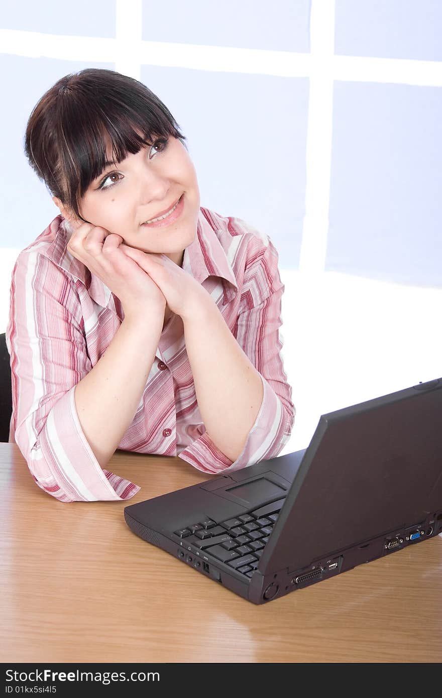 Happy brunette woman with laptop at home