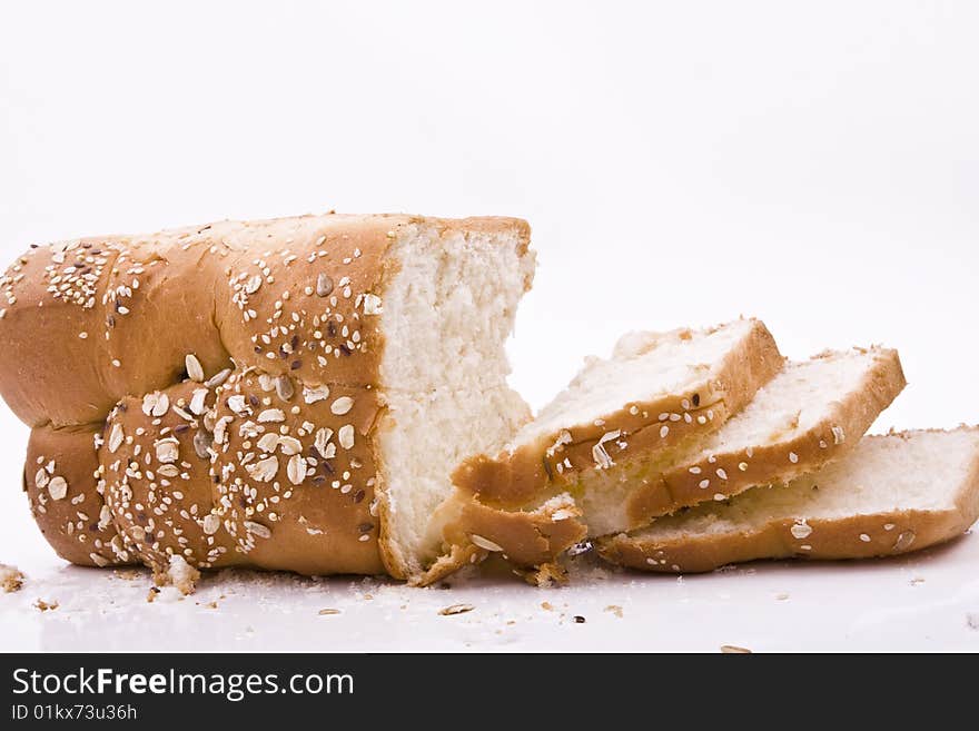 White background, bread in peieces, covered with til seed, cornmeal. White background, bread in peieces, covered with til seed, cornmeal