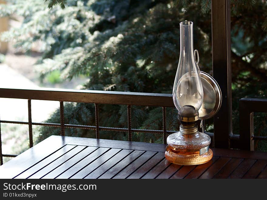 Old petroleum lamp in a wood table