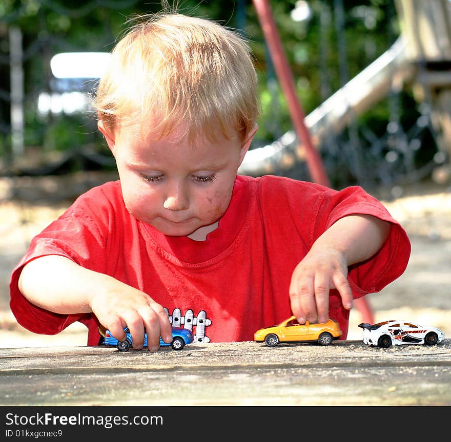 A sweet boy is playing on the playground