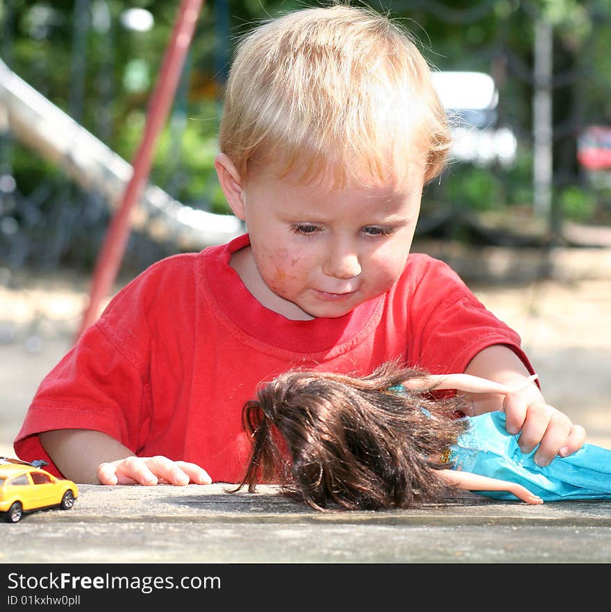 A sweet boy is playing on the playground