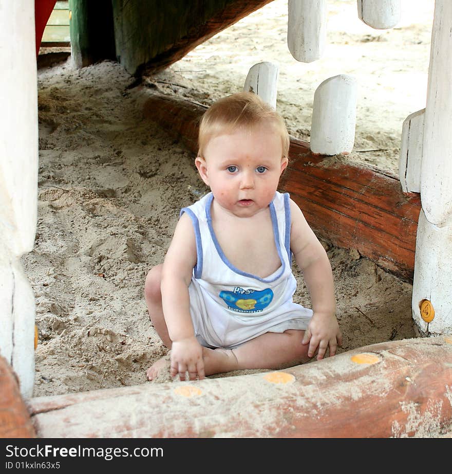 A sweet boy is playing on the playground