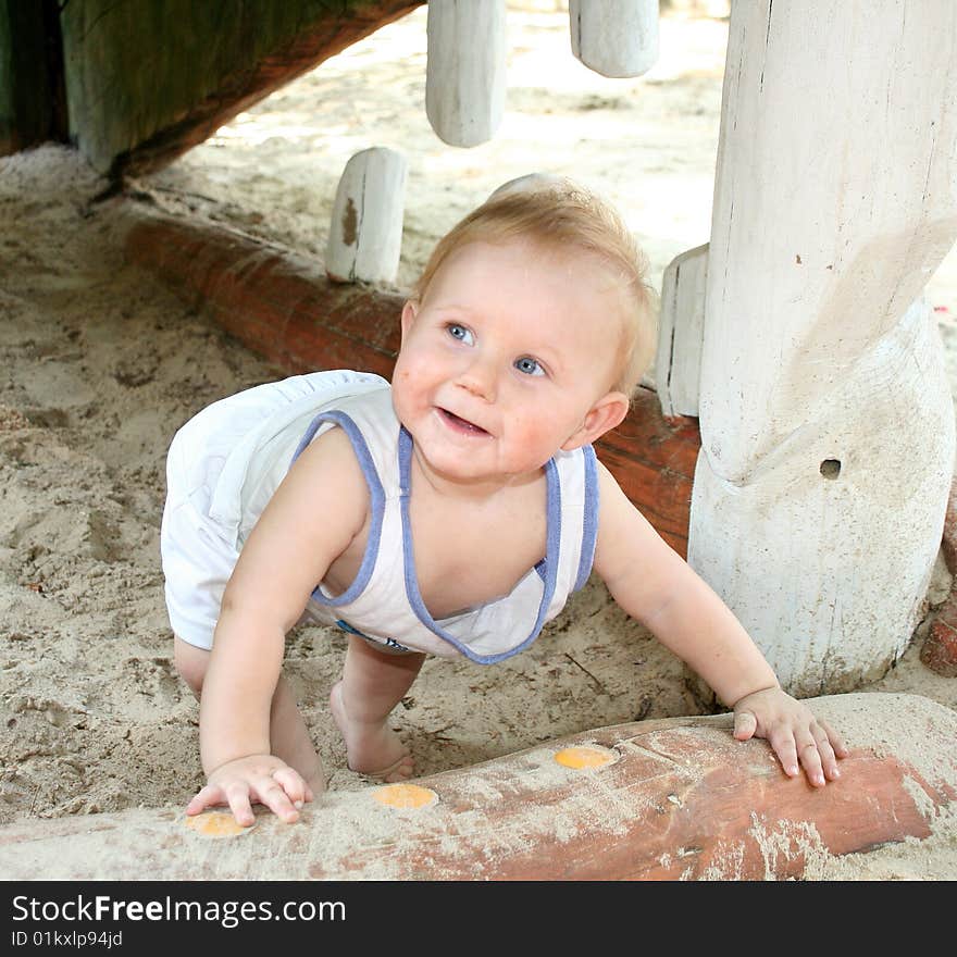 A sweet boy is playing on the playground