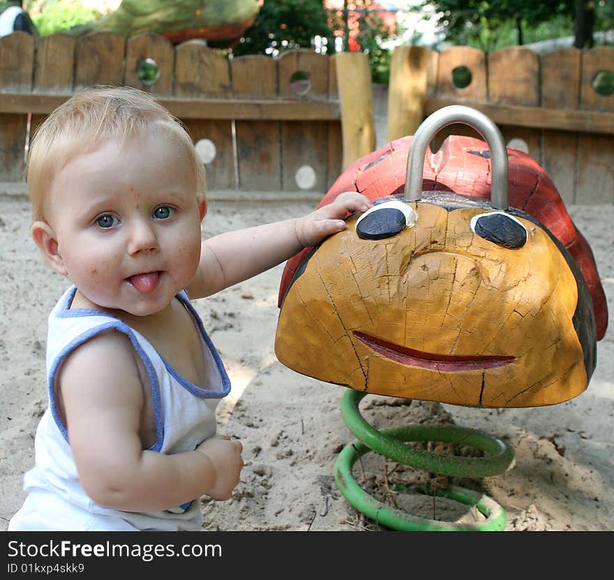 A sweet boy is playing on the playground