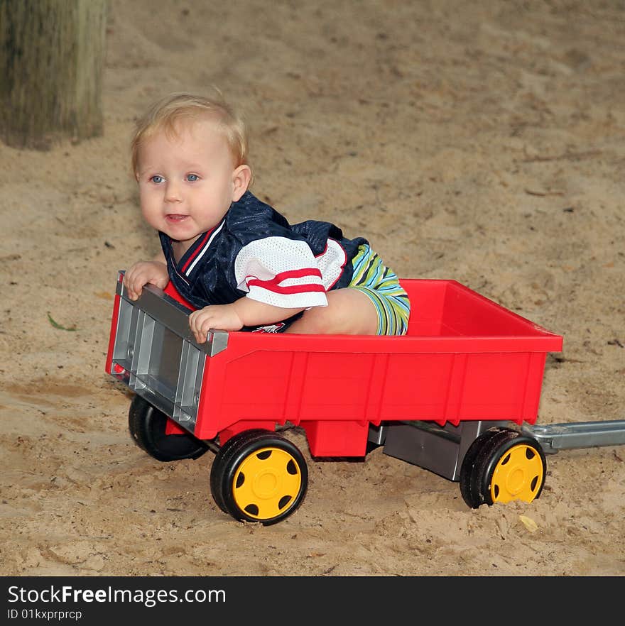 A sweet boy is playing on the playground